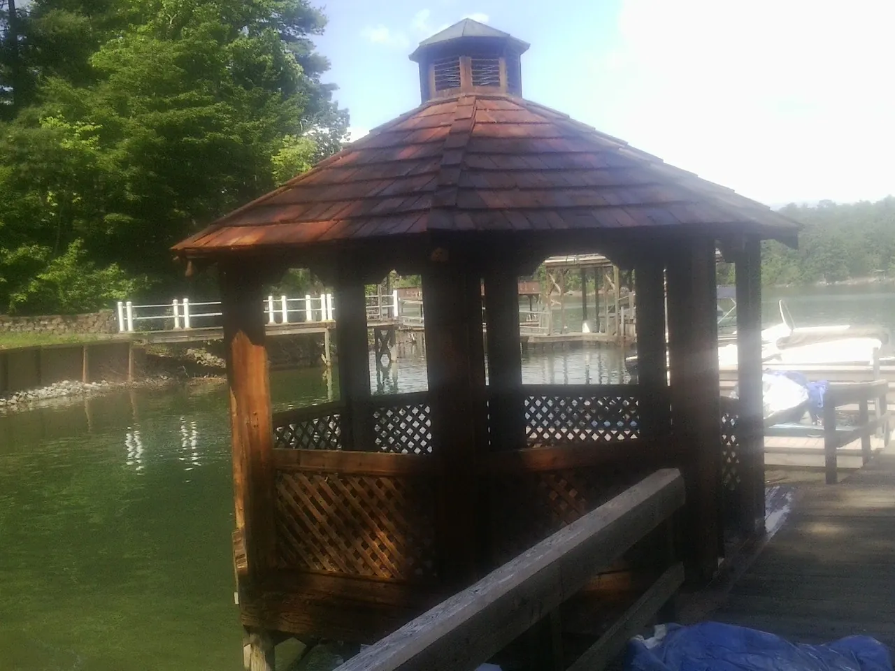 Cedar shake gazebo roof rebuilt on a lake dock in West Lebanon